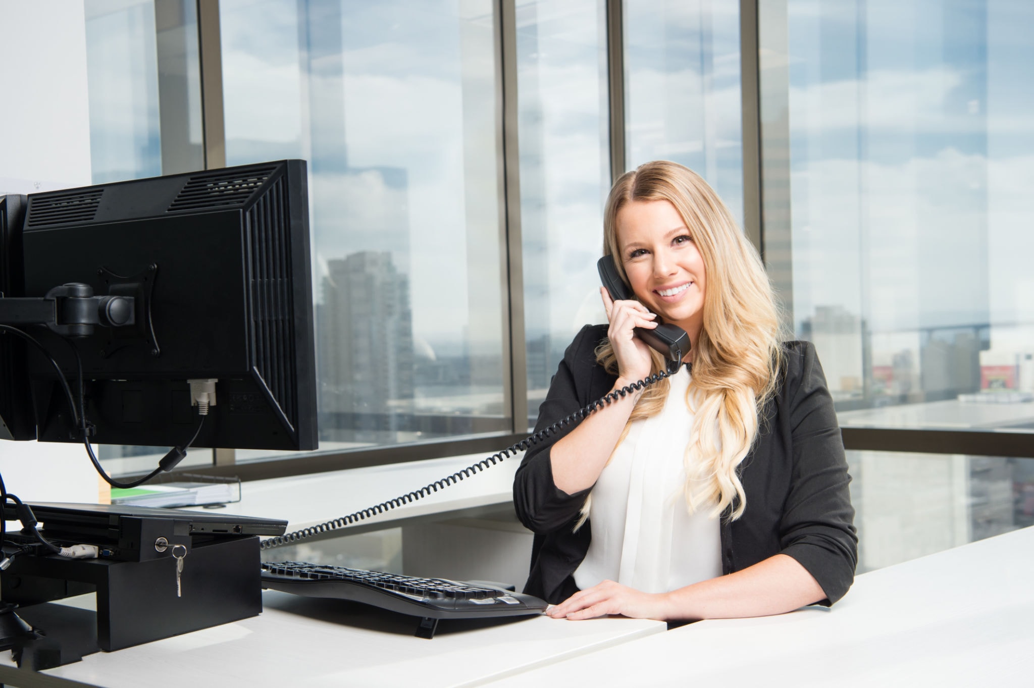 Receptionist speaking with a caller at the office